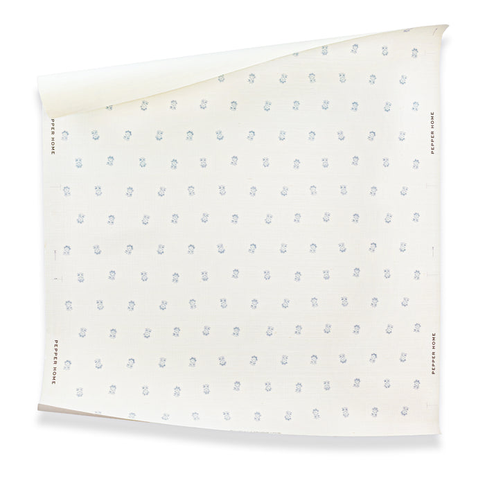 Betty Cornflower wallpaper with delicate blue floral motifs on a pale ground, made to order in the USA with short lead times