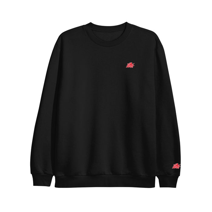 A Bayside plain black Varsity Crewneck Sweatshirt made from recycled polyester fleece, featuring small red graphic logos on the left chest and wrist, displayed on a white background.