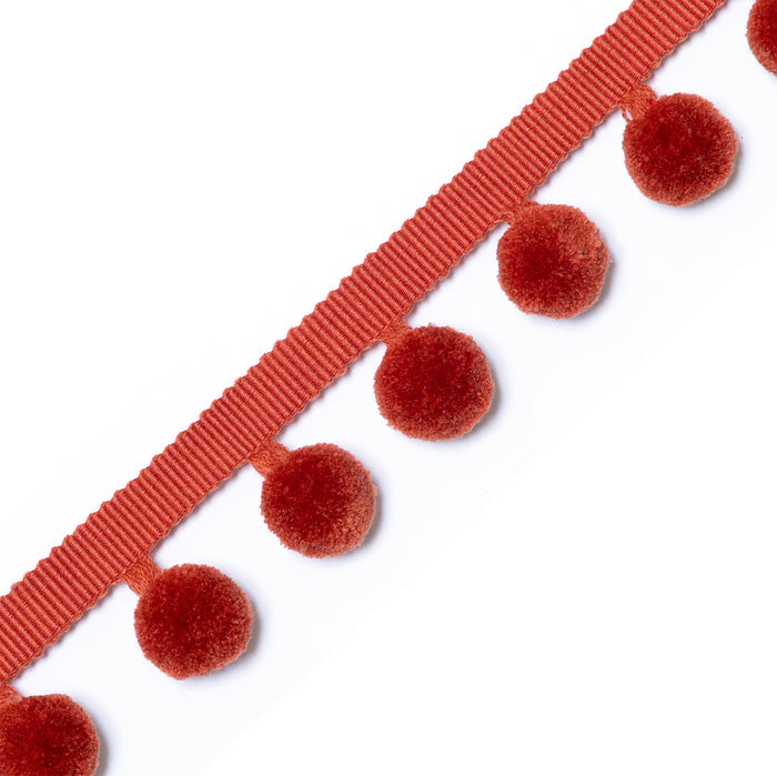 Nutmeg pom pom trim in warm rust tone, perfect for adding softness to custom curtains and cozy spaces.