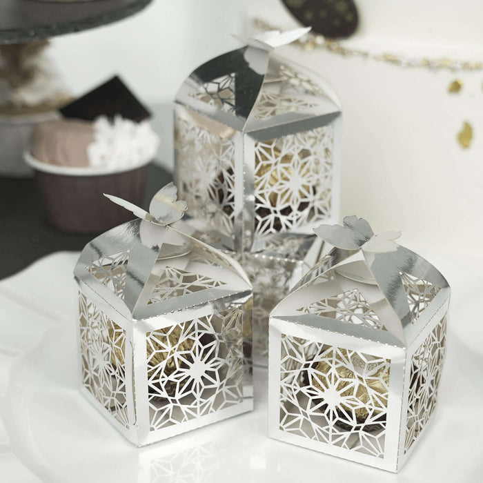 Decorative silver lanterns with intricate floral design and butterfly tops.