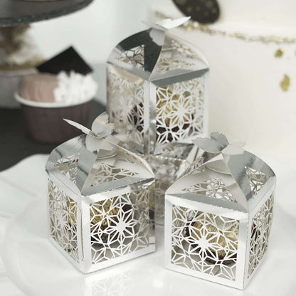 Decorative silver lanterns with intricate floral design and butterfly tops.