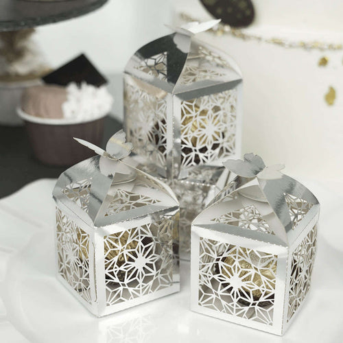 Decorative silver lanterns with intricate floral design and butterfly tops.