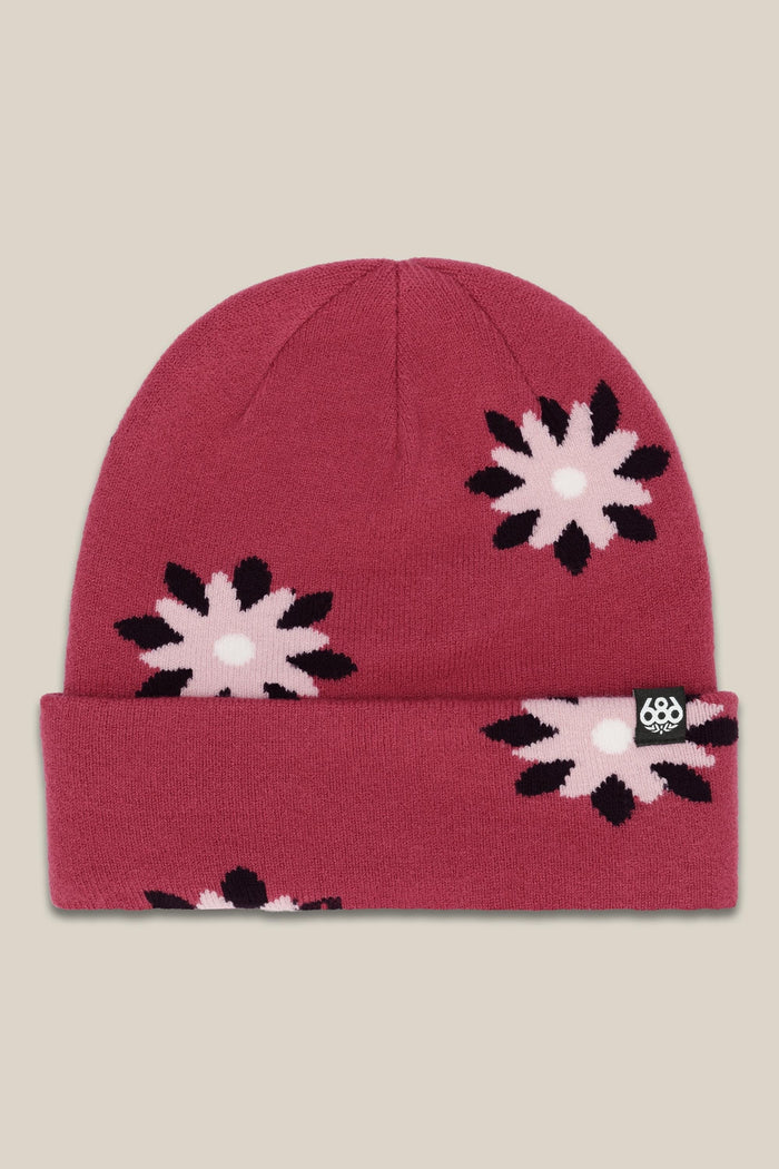 The 686 Womens Dazey Beanie is a red acrylic knit hat with a folded brim, pink and black flower pattern, and a small black tag with the white 686 logo‚Äîperfect for stylish womens winter wear.