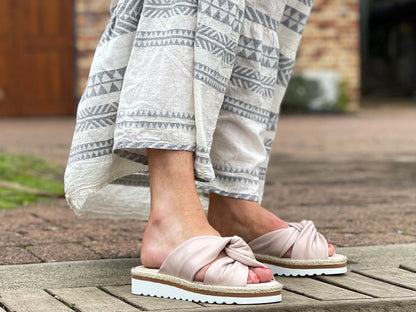 Aerobics are quality European women's sandals and slides. Soft leather with crossover knot detail in nude. Espadrille detail around the sole unit.