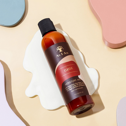 As I Am Moisture Milk leave-in conditioner in a 8 oz bottle on a pastel background for hydration and soft curls