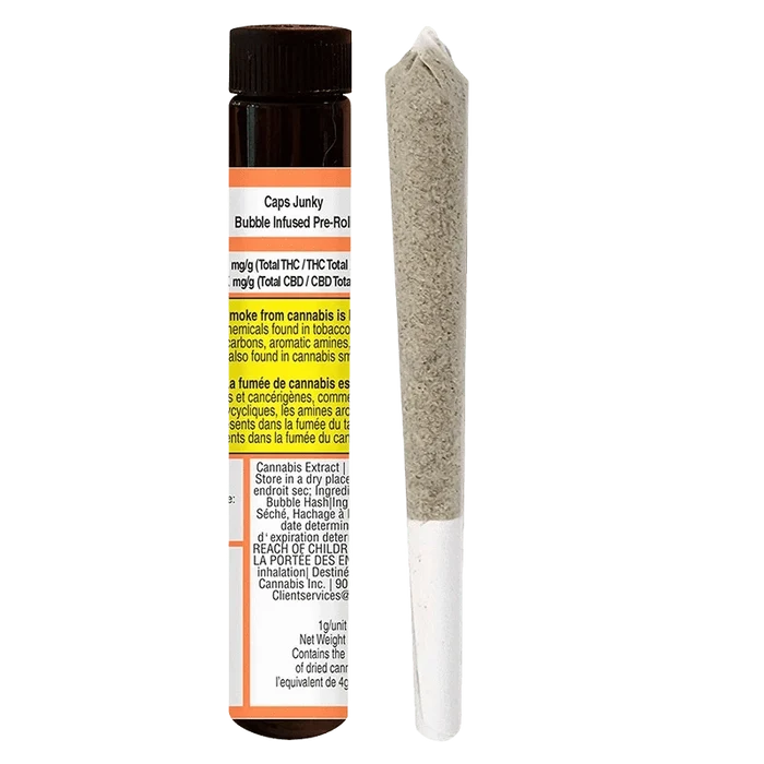 Vertical studio shot of a Caps Junky Bubble Infused PR 1 x 1g pre-roll standing beside its brown plastic tube, both shown on a white background.
