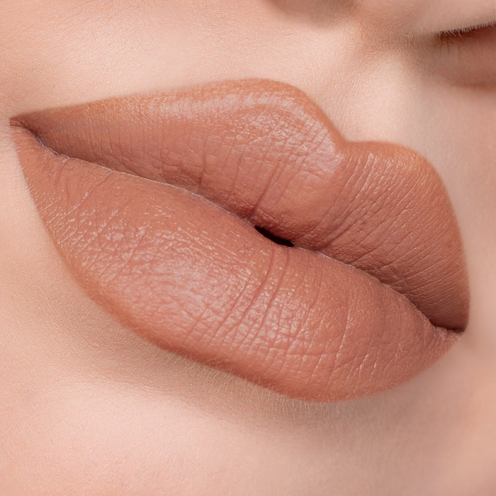 Caramel nude brown lipstick on lips, light skin tone close-up