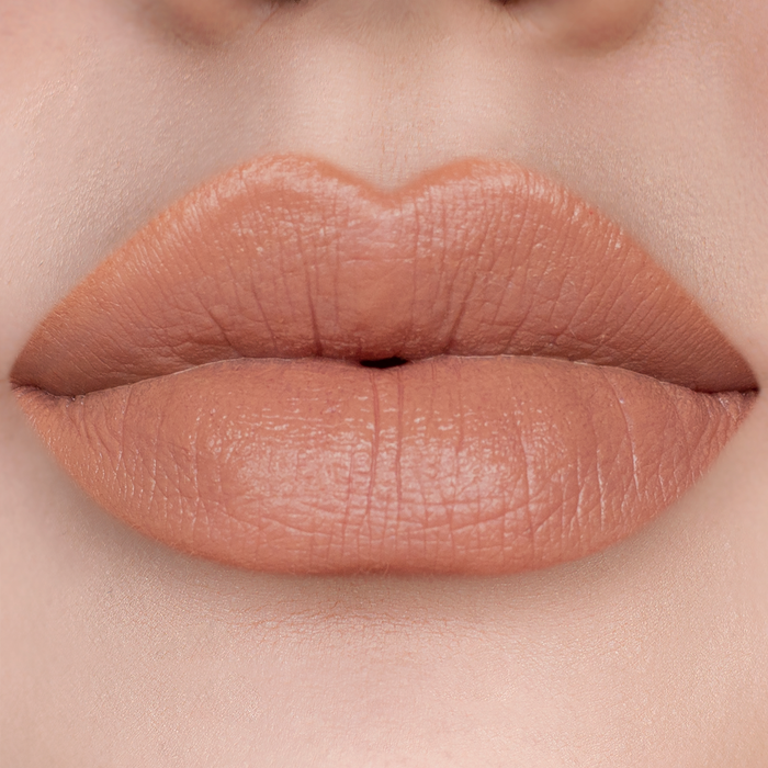 Caramel nude brown lipstick on lips, light skin tone