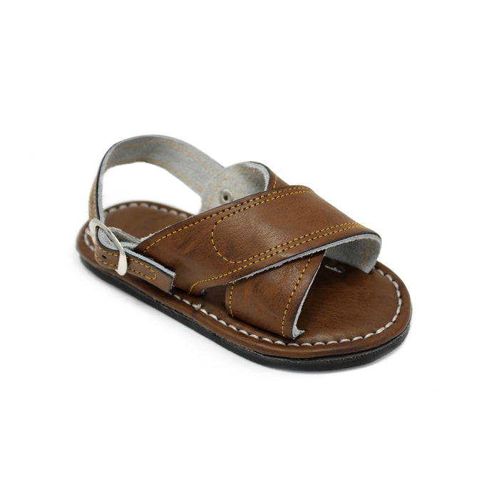 Kid's handmade brown genuine leather Mexican sandals featuring a classic two-strap design, adjustable buckle heel strap, cushioned leather footbed, and durable rubber outsole handcrafted in Mexico.