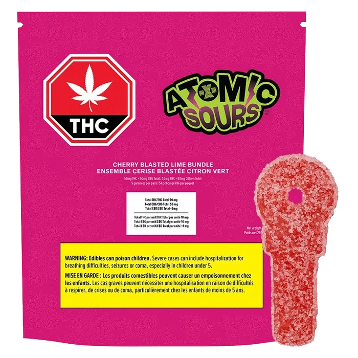 Front-facing bright magenta package labeled "Cherry Blasted Lime Bundle Gummies" with an Atomic Sours logo, THC stop sign, and a red sugar-coated key-shaped gummy alongside.