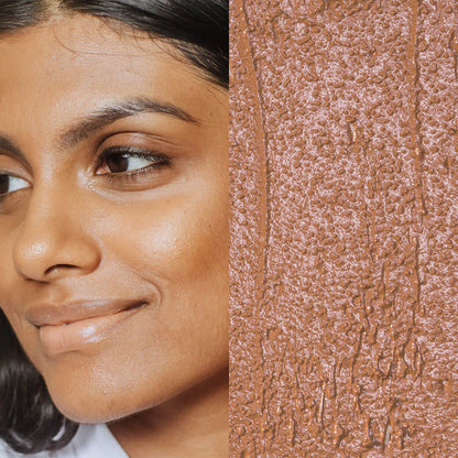 Model next to swatch of Elate Beauty Creme Concealer in the shade 'CN5', for medium neutral skin tones. A two-in-one concealer and illuminator formulated with evening primrose oil, designed to heal and conceal blemishes.