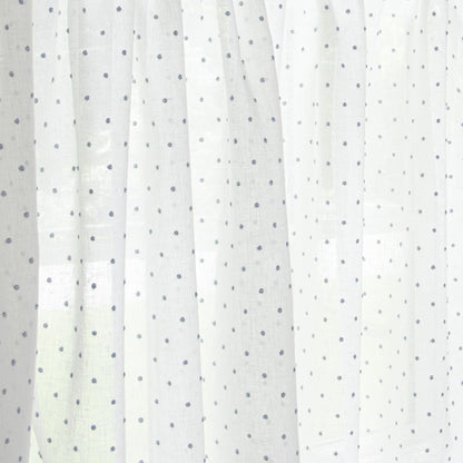 close up of white curtain with sky blue polka dots