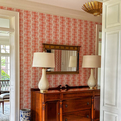 Emma Coral wallpaper with vibrant coral leaf pattern in a bright room, made-to-order with short lead times, manufactured in the USA
