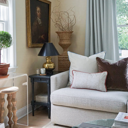 Emma Sand pillows with subtle pattern and rust piping on a cozy sofa, made-to-order in the USA with fast turnaround