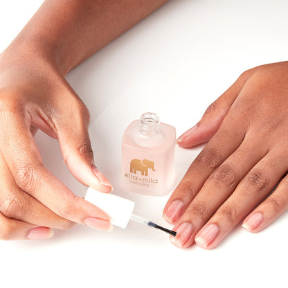 Applying First Aid Kiss nail strengthener to bare nails