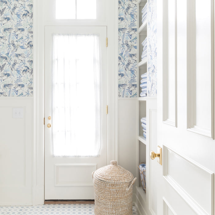 Bright laundry room with Frida Blue wallpaper showcasing hand-painted blue tigers and botanicals, made-to-order, USA made, quick delivery