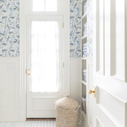 Bright laundry room with Frida Blue wallpaper showcasing hand-painted blue tigers and botanicals, made-to-order, USA made, quick delivery