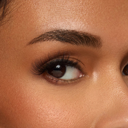 Frisky false lash with natural inner corners transition into flared wispy outer corners shown on an eye
