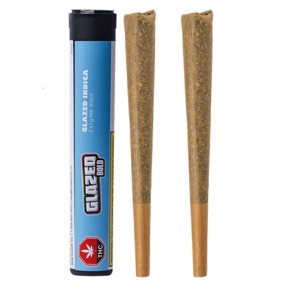 Product-shot front view of the Glazed Indica PR 2 x 1 g tube standing beside two cone-shaped pre-rolls on a white background.