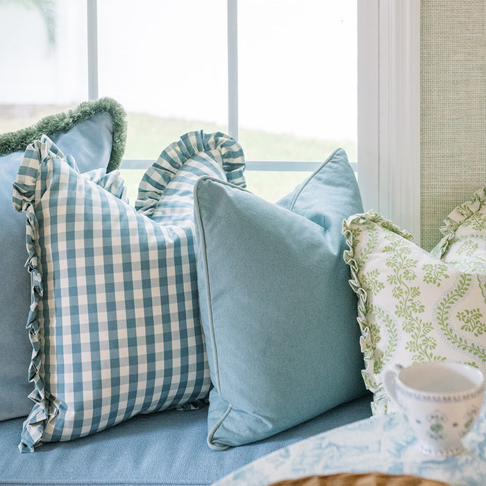 Millie Harbor blue gingham and solid throw pillows styled on a sofa, made to order in the USA with short lead times