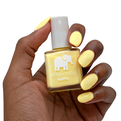 Hooray of Sunshine yellow nail polish on a deep skin tone, hand holding the bottle