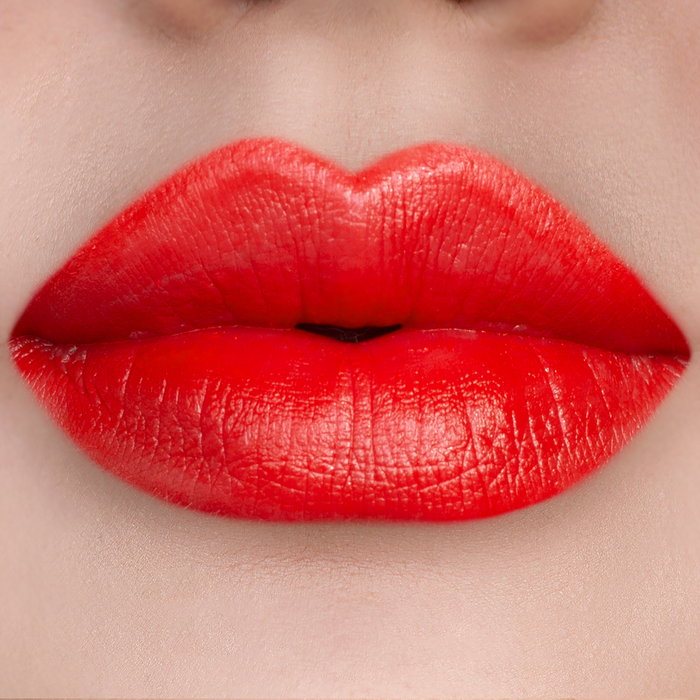 Island Girl bright orange red lipstick on lips, light skin tone