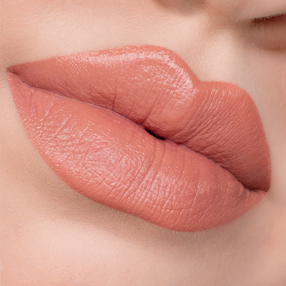 Just Enough peachy nude lipstick on lips, light skin tone close-up