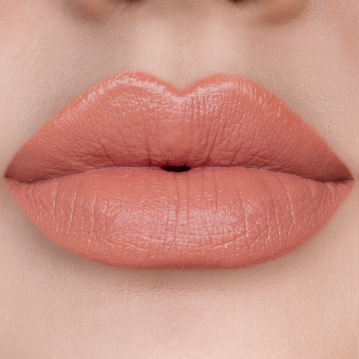Just Enough peachy nude lipstick on lips, light skin tone