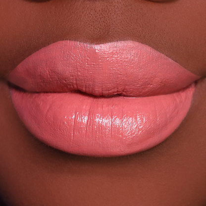 Just Enough peachy coral lipstick on lips, medium-deep skin tone