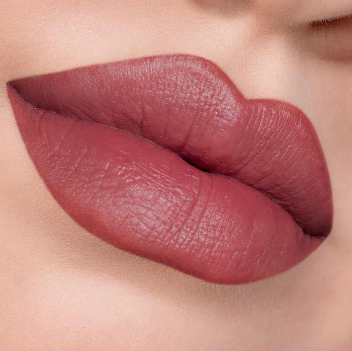 Just Right rosewood lipstick on lips, light skin tone close-up