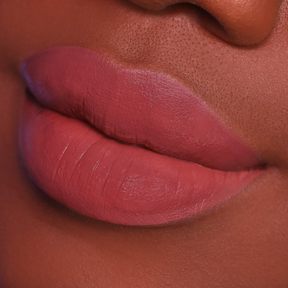 Just Right rosewood lipstick on lips, deep skin tone close-up