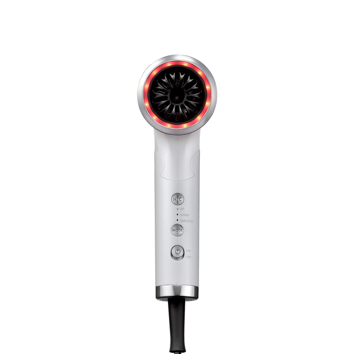 Silver hair dryer with red light on a white background