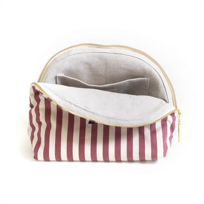 Louisa Cranberry pouch with vertical cranberry stripes, gold zipper, and organized linen interior pockets for custom use