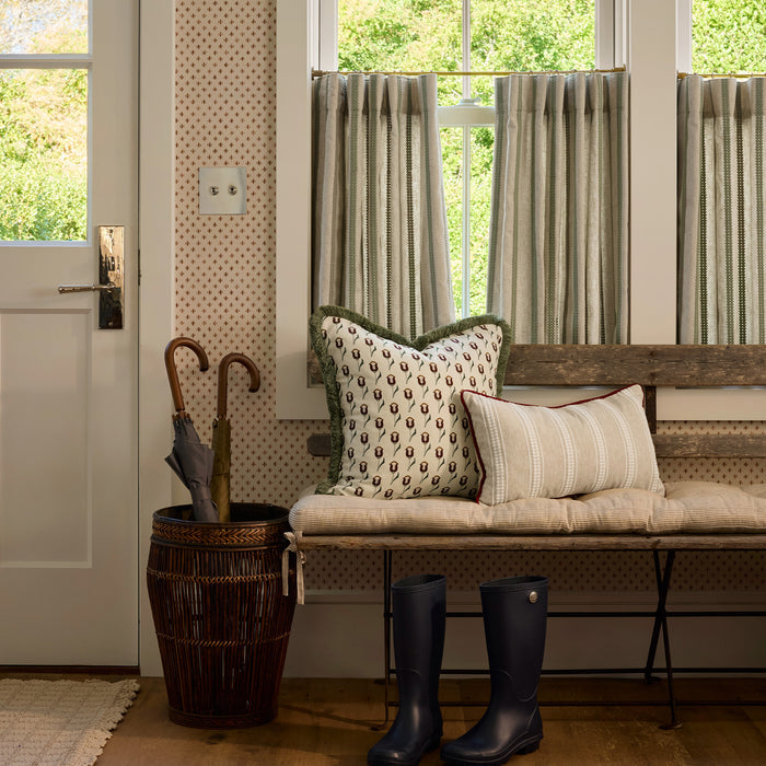 Cozy entryway featuring Maude Chestnut wallpaper with warm chestnut dots on cream, paired with natural decor accents.