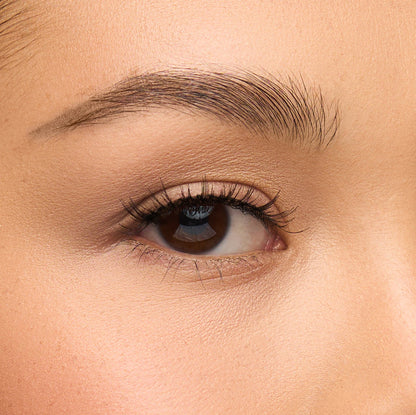 Mika a short, round lash with natural volume and delicate spiky fibers for a wet mascara effect shown on an eye.