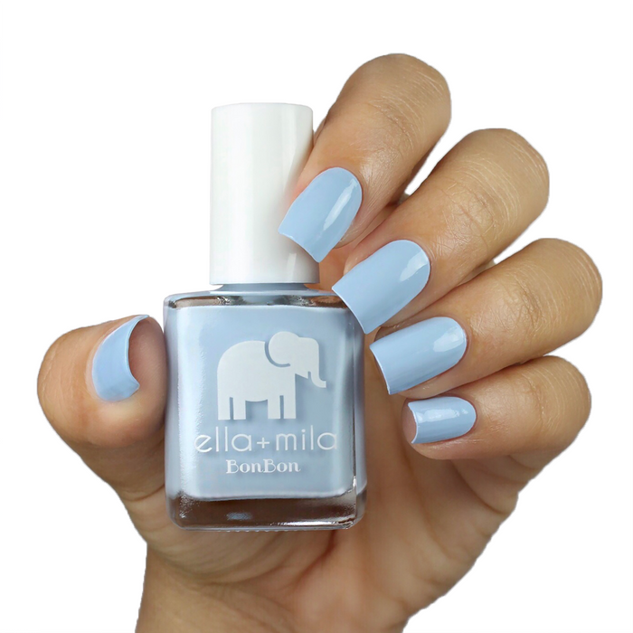 My Rain-beau Cinderella blue nail polish on a medium skin tone, hand holding the bottle