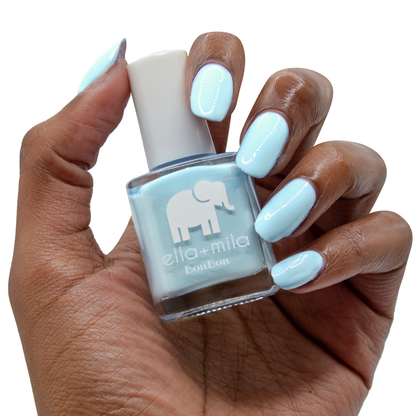 My Rain-beau Cinderella blue nail polish on a deep skin tone, hand holding the bottle