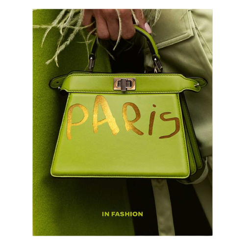 Green handbag with 'Paris' written on it, held by a person wearing a green coat.