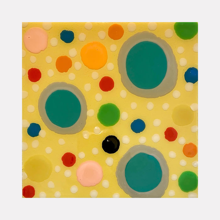The artwork 'Piece of Cake 912' by Lori Kirkbride features vibrant polka dots in varying sizes on a soft yellow background. Three large turquoise circles with gray borders dominate the composition, surrounded by smaller dots in red, orange, pink, green, and navy blue. The acrylic and resin create a playful, modern abstract pattern with a glossy finish.