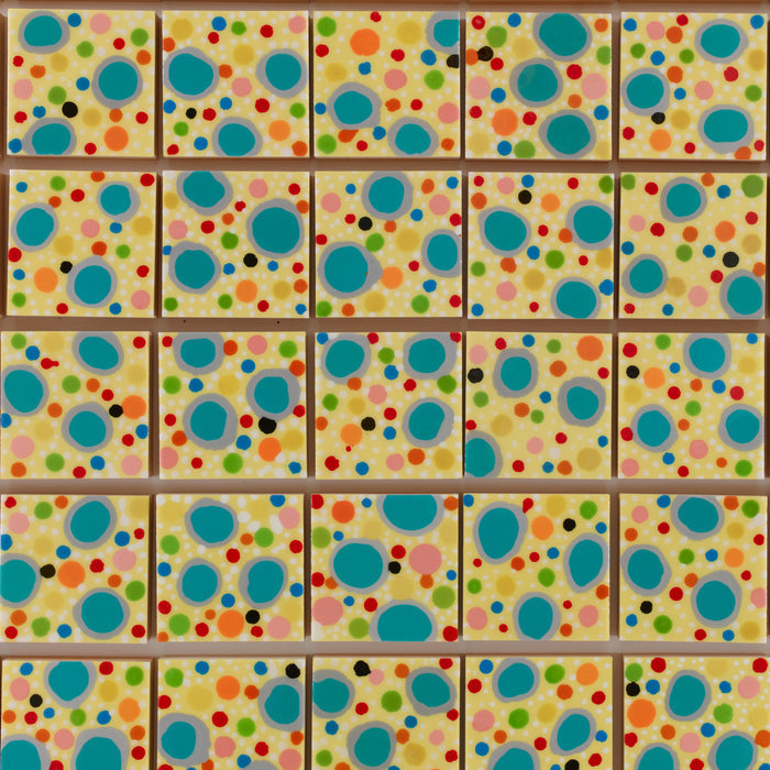 The artwork 'Piece of Cake 912' features a vibrant polka dot pattern arranged in a grid of squares. Turquoise blue circles dominate the composition, scattered among smaller red, green, and orange dots on a warm cream background. The playful, contemporary pattern showcases acrylic polymer and resin on panel by Lori Kirkbride.