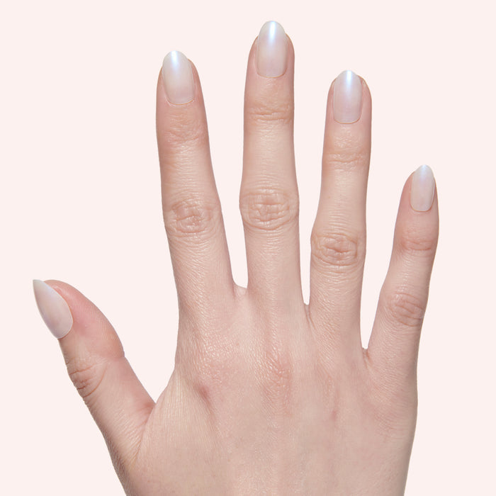 Pink Goldfish | Round | Extra Short subtle shimmery pink iridescent press on nails in extra short round shape displayed on hand
