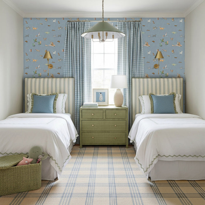 Twin bedroom with Pippa Powder wallpaper in soft blue featuring animals, paired with green plaid curtains and striped headboards