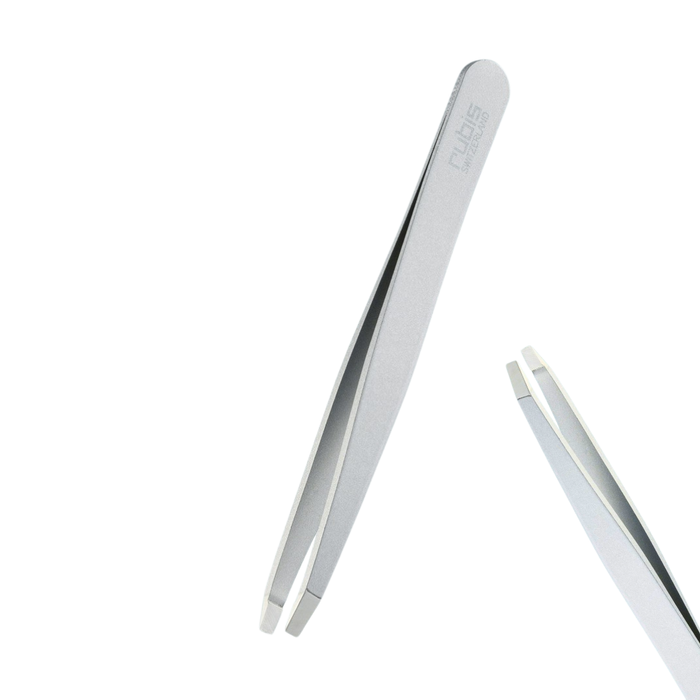 T115 Rubis Straight Point Ion Eyebrow Tweezer | A pair of metallic silver tweezers with a brushed finish, featuring a subtle Rubis brand engraving on the handle and a second pair shown partially cropped on the right against a solid white background.