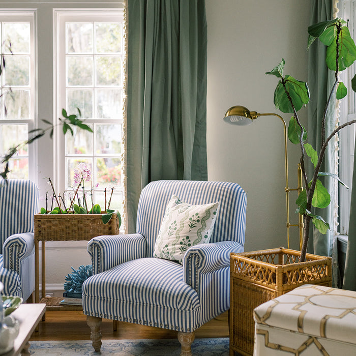 Sage made-to-order curtains in soft green paired with striped armchair in cozy room, crafted with quality and quick delivery in the USA