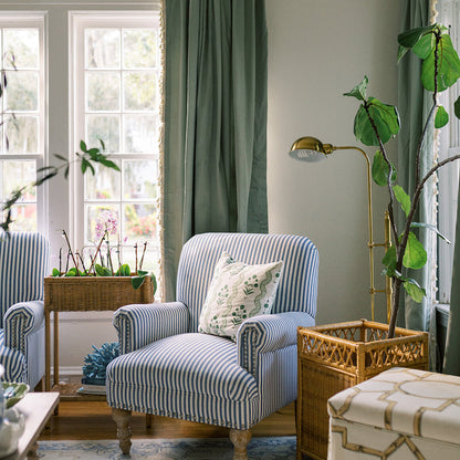 Sage made-to-order curtains in soft green paired with striped armchair in cozy room, crafted with quality and quick delivery in the USA