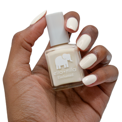 Secret Garden creamy nude nail polish on a deep skin tone, hand holding the bottle
