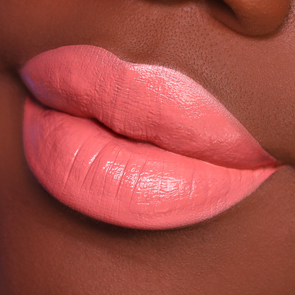 Set Plans warm peach lipstick on lips, deep skin tone close-up