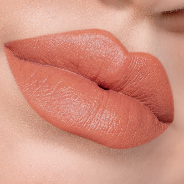 Set Plans warm peach nude lipstick on lips, light skin tone close-up