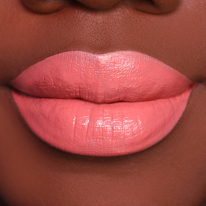 Set Plans peach coral lipstick on lips, medium-deep skin tone
