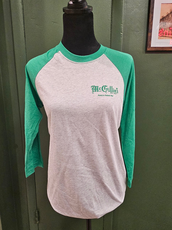 Green and white apron with 'McGrillin's' logo on a green surface